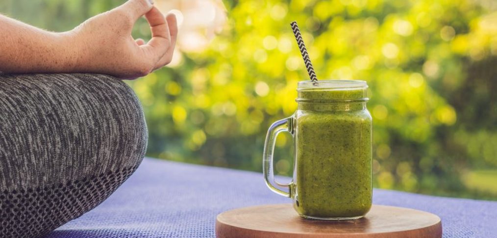 Woman relaxing with a green smoothie