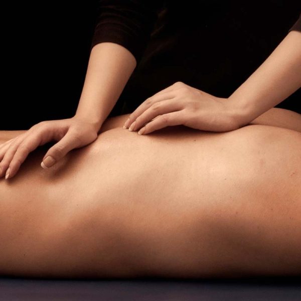 Close-up of hands providing soothing back massage with care and expertise